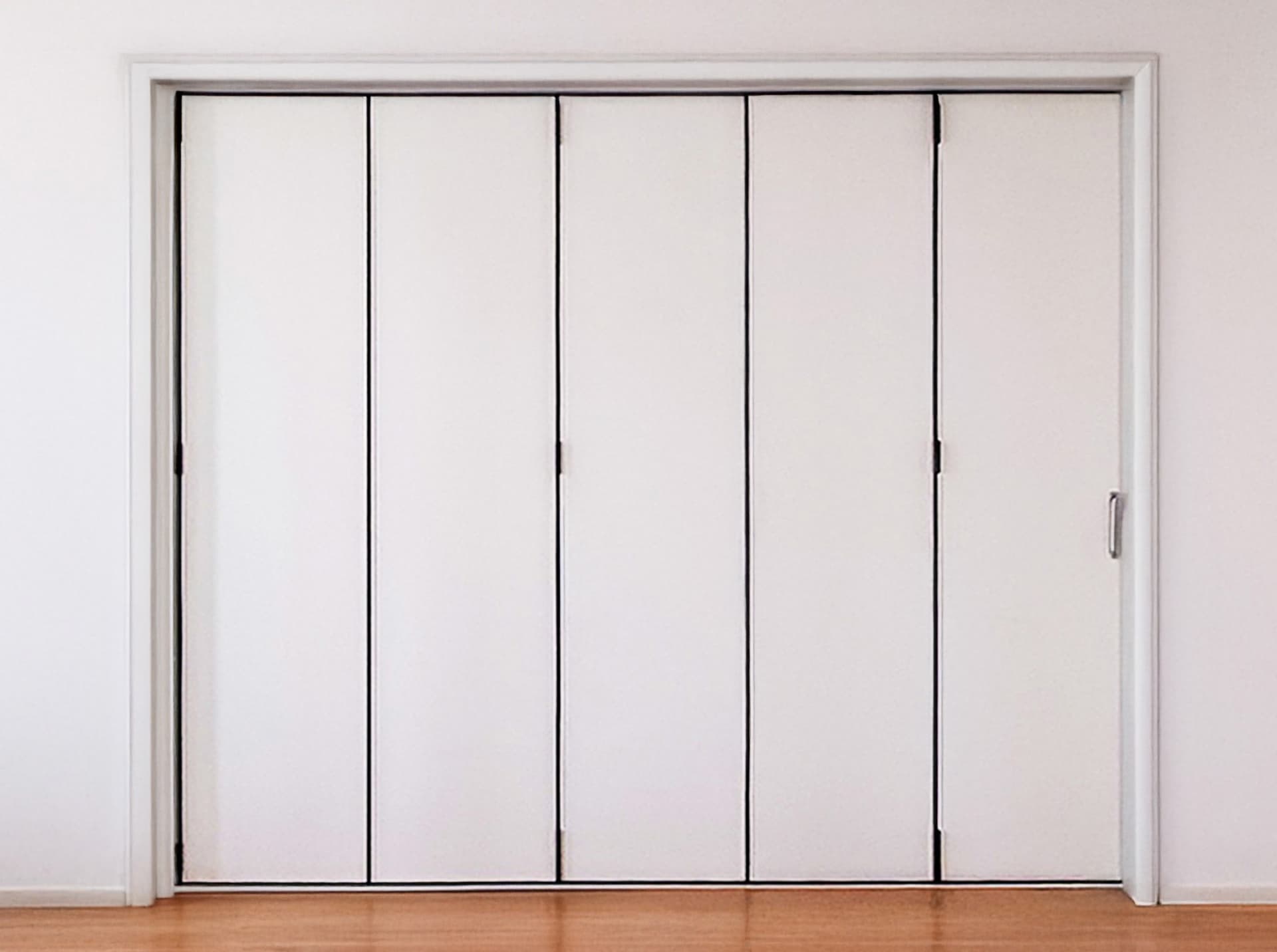 Glass folding door installed in a modern cafe interior showing transparency and openness